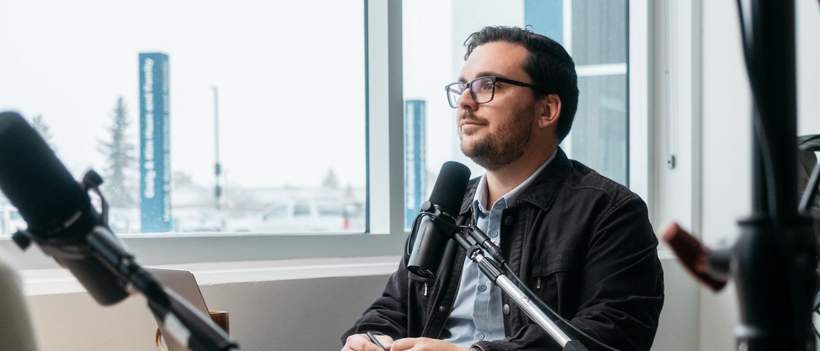 Andrew at the microphone during a recording in Red Deer